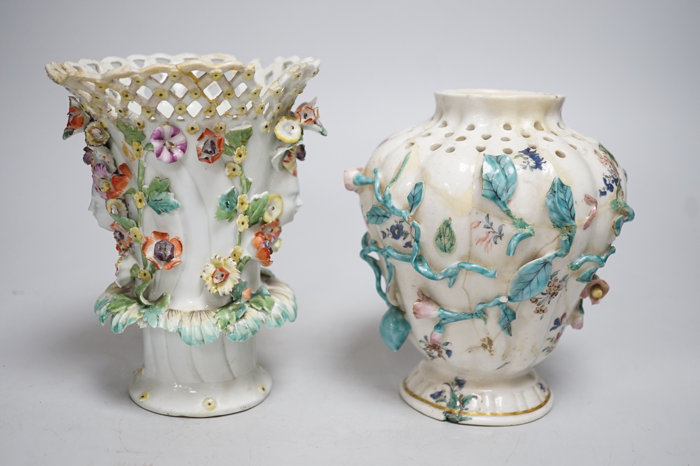 An 18th century Chelsea pot pourri vase, red anchor period, encrusted and painted with leaves and flowers and a Bow frill vase with mask heads encrusted with flowers. Tallest 16.5cm